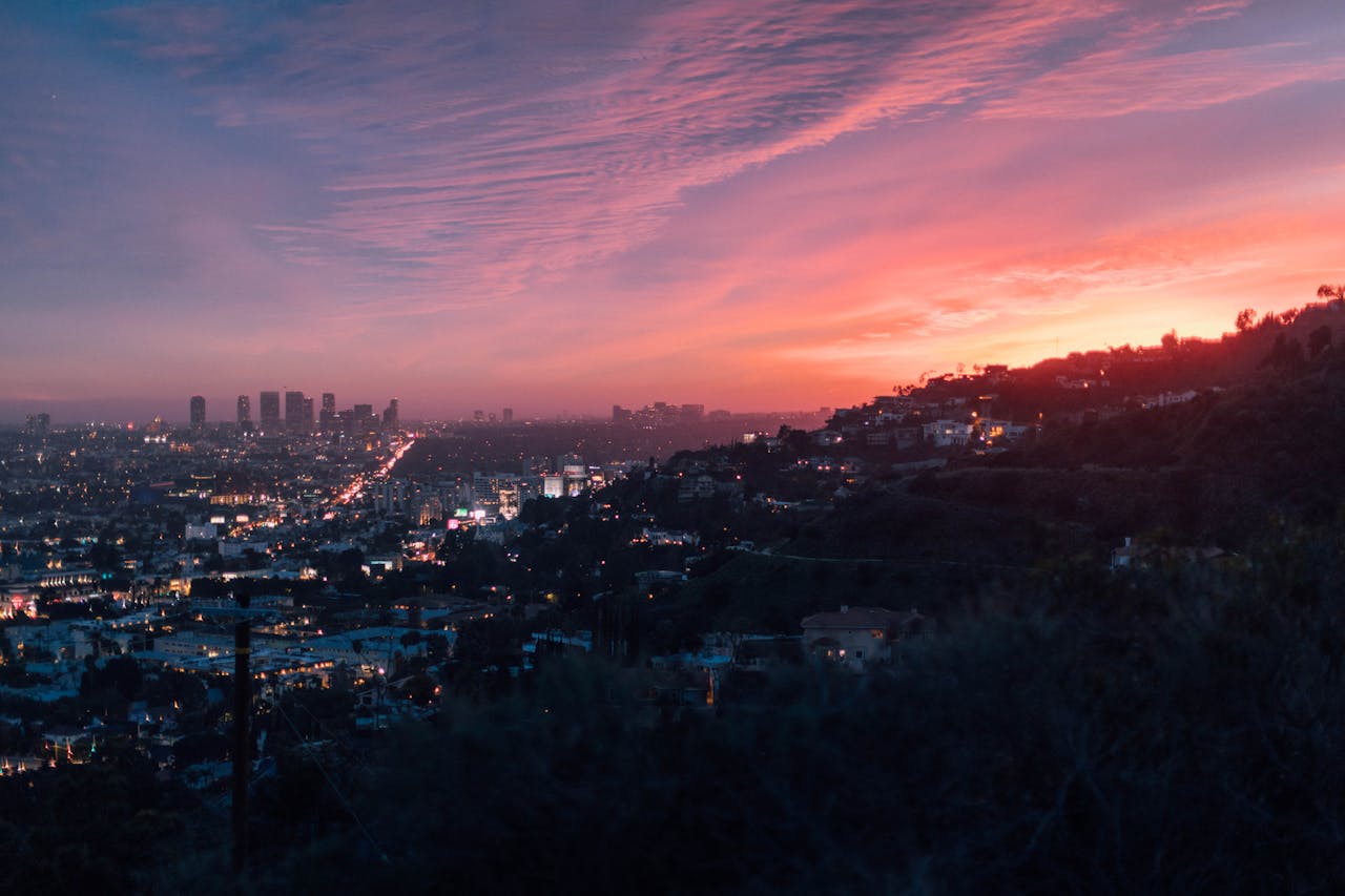 A pink and purple sunset over the city of Los Angeles, a great city to get a California construction loan.