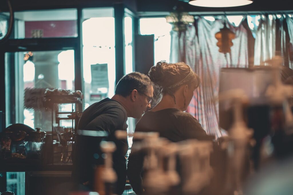 A couple who own a cafe are working behind the counter. They are ideal candidates for Oregon bank statement loans.