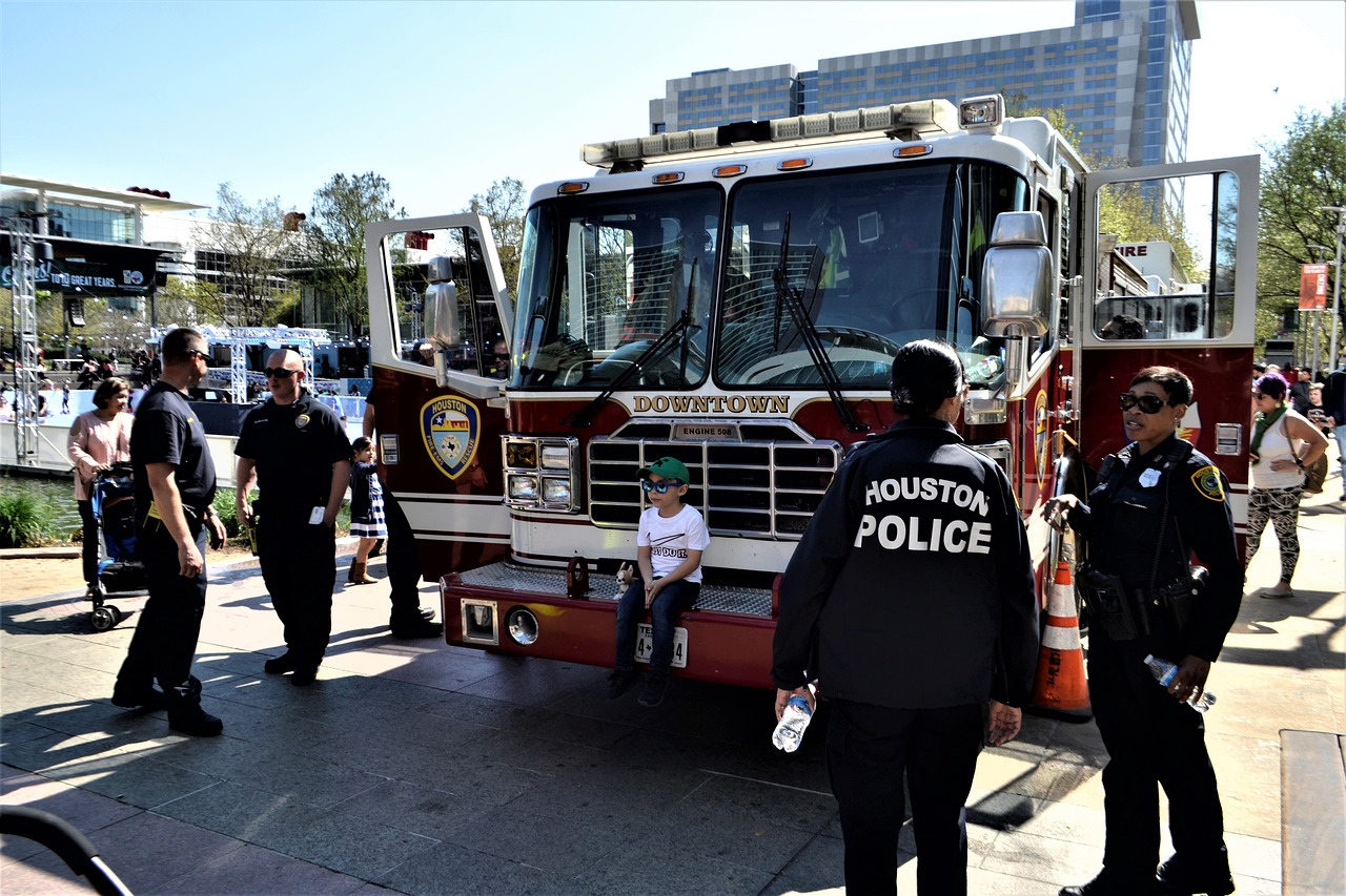 A fire truck with several police officers and fire fighters, all great candidates for first responder home loans.