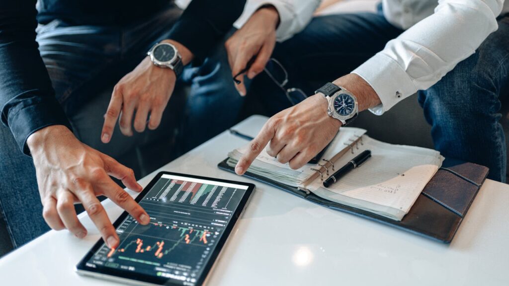 Two men analyzing market volatility, which is an important pros and cons of DSCR to consider.