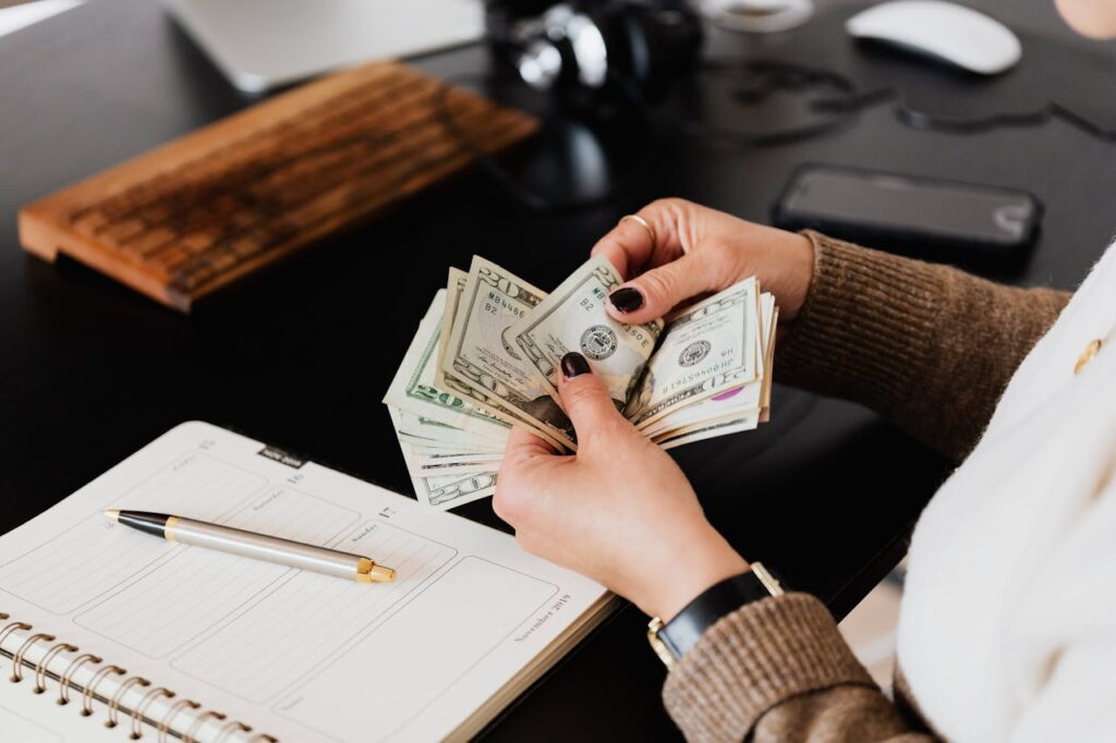 A woman is counting cash that she got from a cash-out refinance.