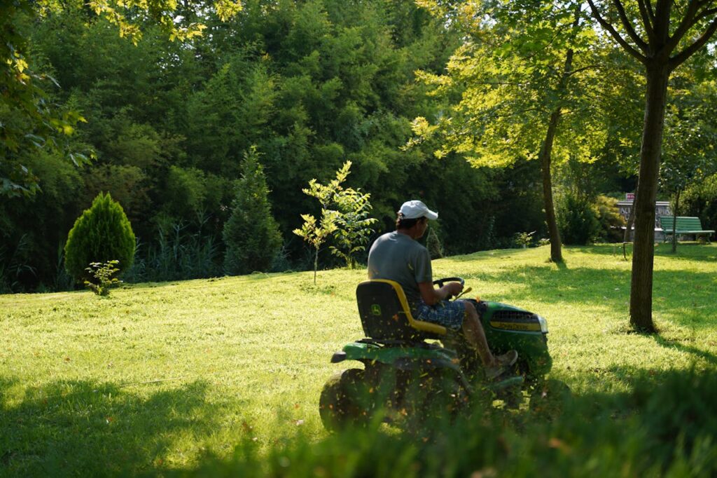 A landscaper mowing the lawn, which is a cost to consider in your rental property analysis.