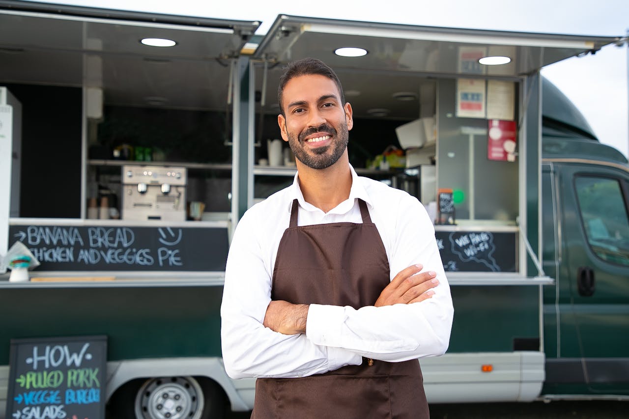 A food truck owner standing in front of his truck is someone who should research myths about self-employed mortgages.