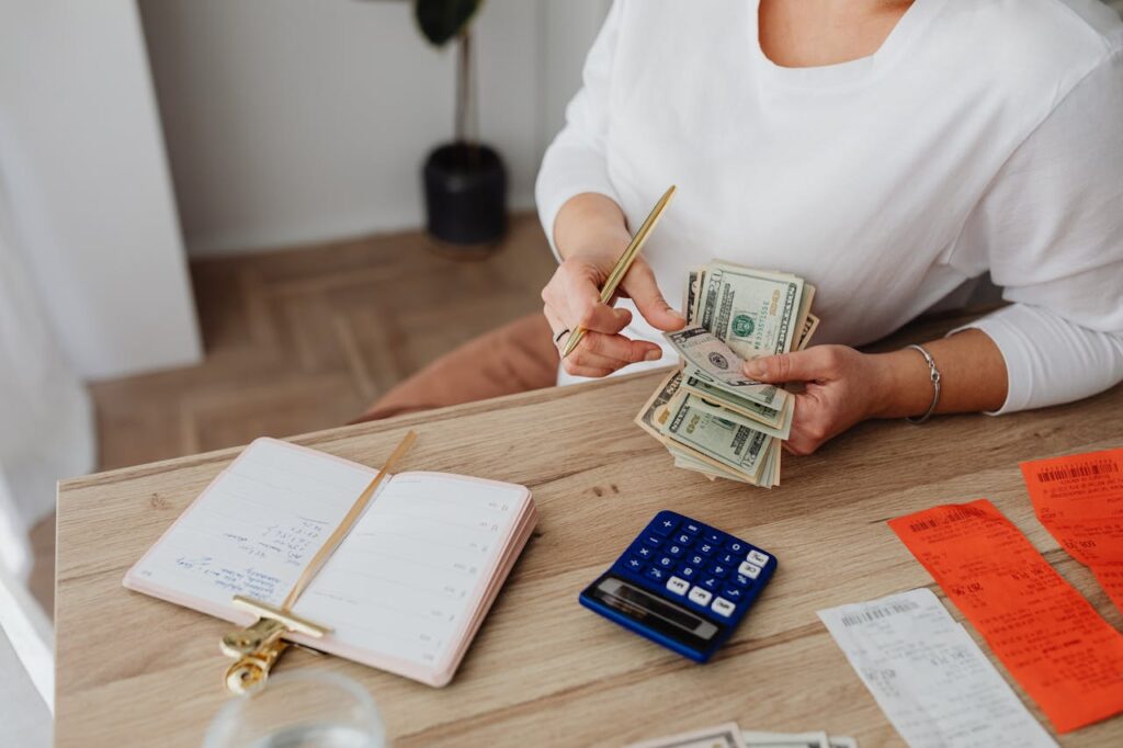 A woman is counting out cash to see if she has enough for a conventional loan Florida down payment. 