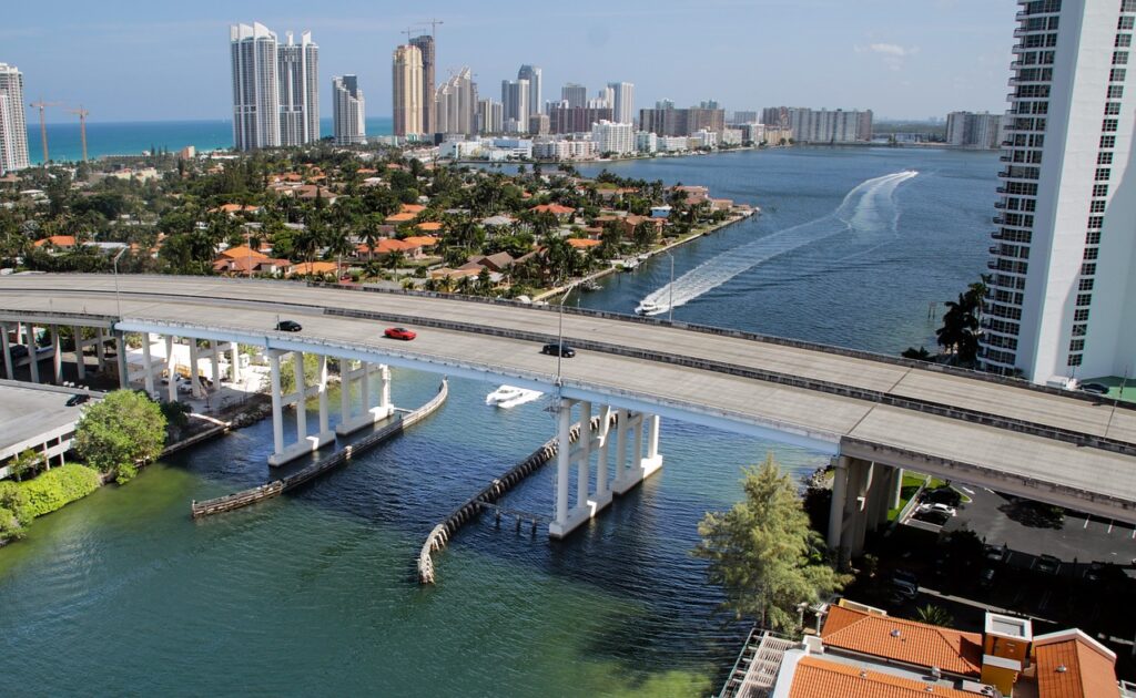 A bridge in Miami with the skyline in the background, which is a beautiful and scenic place to buy a home and finance it with a conventional loan Florida. 