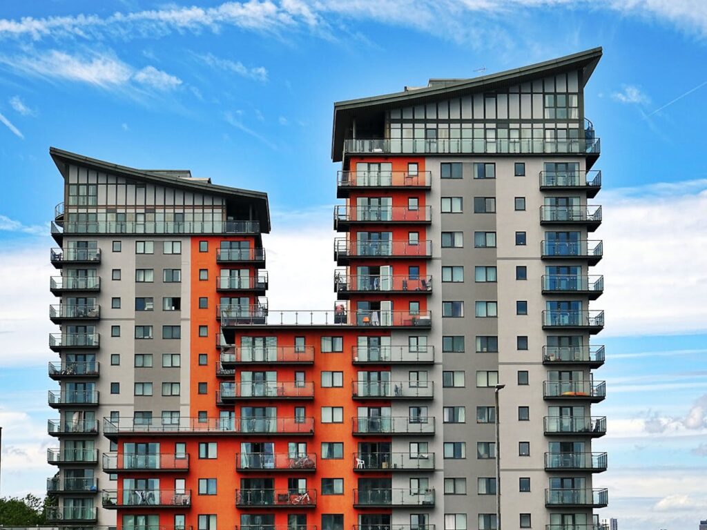 The exterior of an apartment building with orange and grey paint that was financed with a DSCR loan Connecticut. 