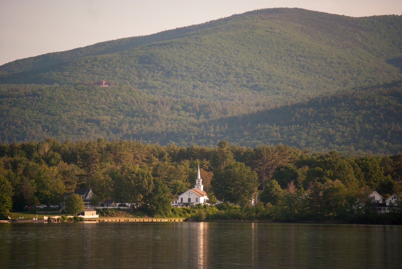 A view of Tuftonboro, New Hampshire from the lake with mountains in the background, reflecting the opportunity for DSCR loan New Hampshire options.