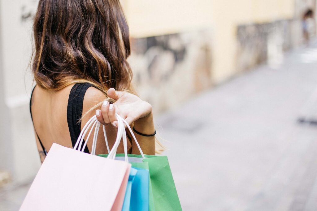 A woman is holding shopping bags after the Federal Reserve interest rate cuts made borrowing cheaper. 