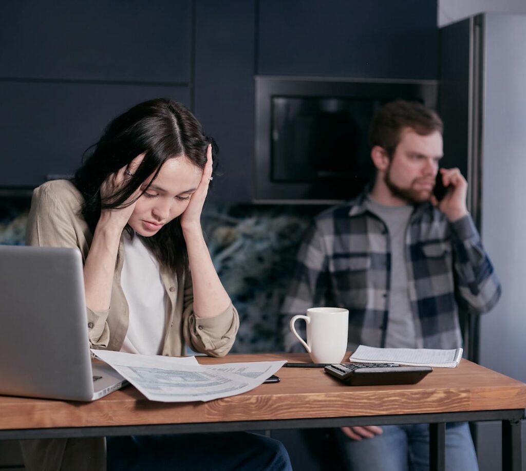 A couple is making a call to the bank since they missed their first mortgage payment. 